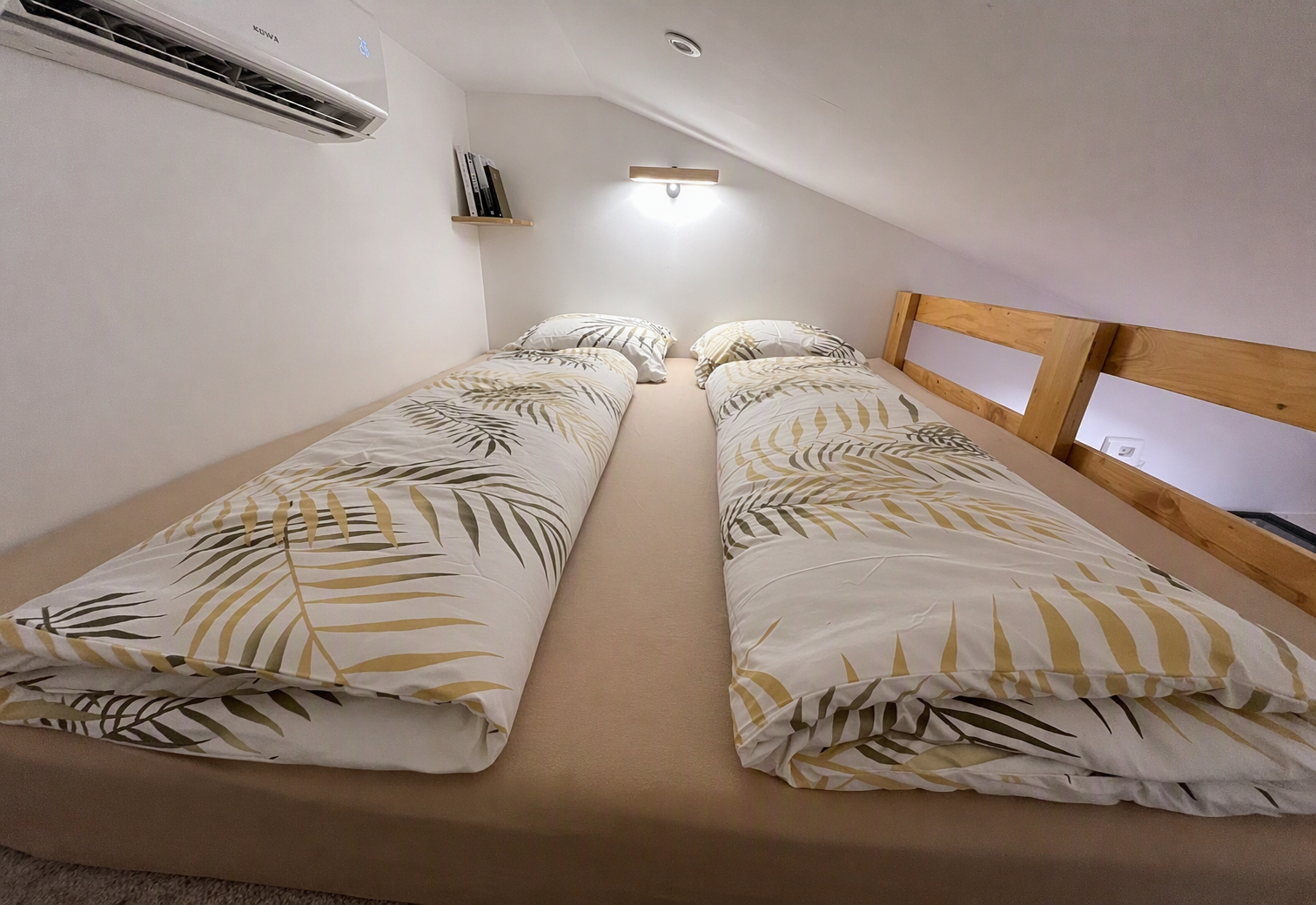Wide view of the mezzanine sleeping area with two beds side by side