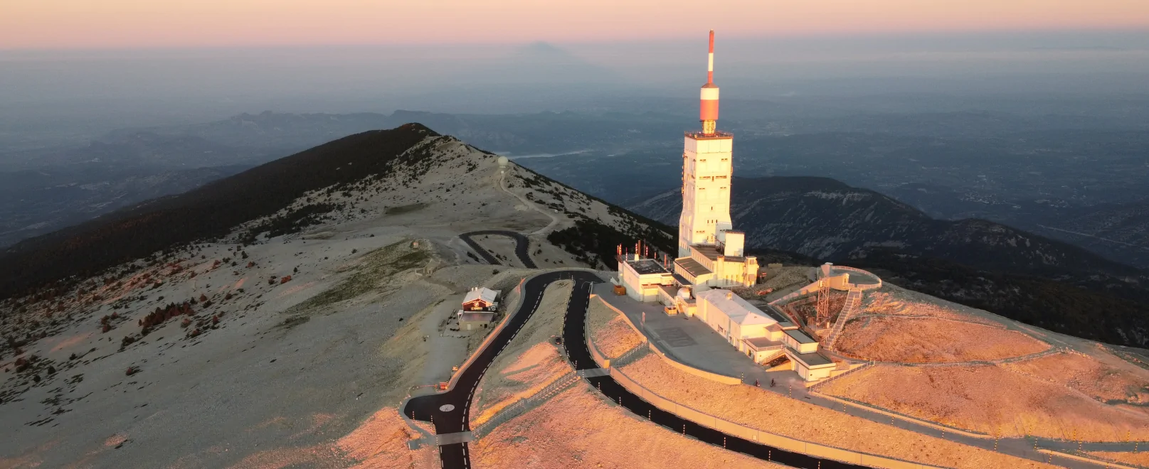 Aerial view of Mont Ventoux summit with its tower and winding road