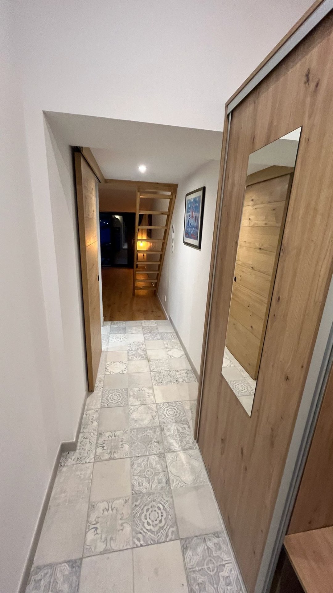 Hallway with patterned tiles leading to the studio